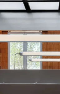 Suspended lighting in a modern office setting.