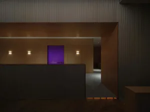 Modern reception desk with wooden panels and purple feature wall.