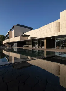 A modern architectural building with concrete and glass materials.