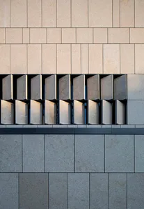Modern building facade with concrete tiles and concrete columns.