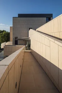 A modern building featuring sleek concrete walls and geometric design.