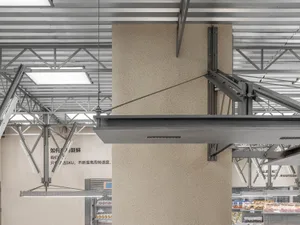 Modern interior design featuring metal beams and concrete cladding.