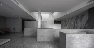 Modern office lobby with marble walls and floors, showcasing sleek and minimalist design