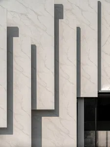 Modern exterior building facade with marble mosaic tiles.