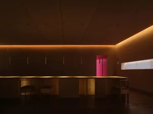 A minimalist restaurant interior with wooden features.
