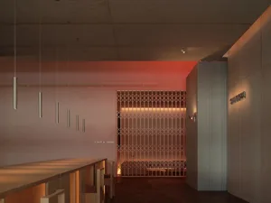 A modern restaurant interior with metallic, glass, and wooden elements.