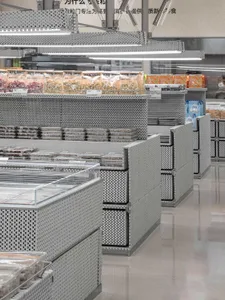 A modern supermarket with metallic shelves and illuminated displays.