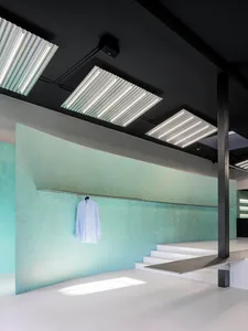 A modern clothing store with concrete walls and minimalist design.