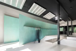 A modern commercial space with a minimalist design, featuring a concrete floor and walls.
