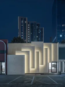 A modern storefront with illuminated marble panels and a sleek design.