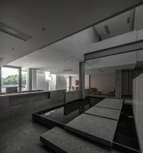 A modern office space featuring concrete and glass materials.