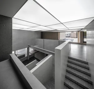 A modern office space featuring a combination of concrete and marble materials.