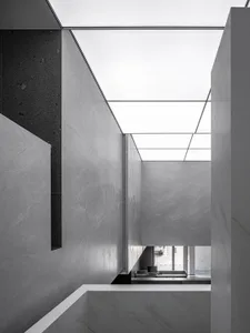 A modern office interior featuring gray marble walls and floors.