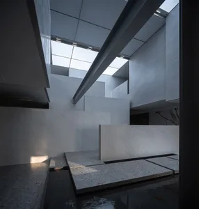 Modern office lobby interior with glass and concrete materials.