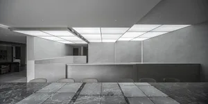 A modern office space featuring a sleek marble counter and minimalist design.