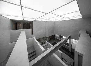 A modern office space with concrete walls and floors.