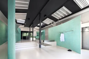 Modern retail clothing store interior with concrete and glass materials