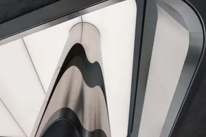Metallic architectural facade with geometric lines and curves