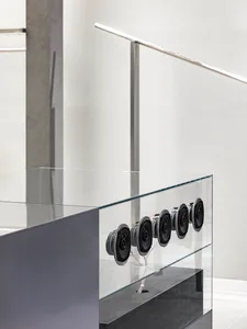 A modern interior space featuring a glass balustrade with a minimalist design.