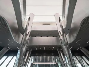 A modern, minimalist office lobby with metallic columns and a sleek, open design.