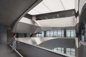 A modern office interior featuring a combination of concrete and glass materials.