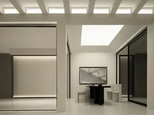 A modern, minimalist residential interior featuring a concrete floor and large windows allowing natural light to flood the sp