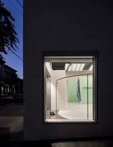 A modern retail storefront features large glass windows and minimalistic interior design elements.