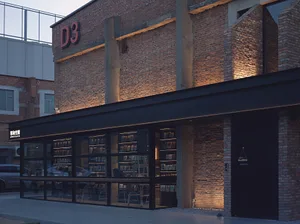 Modern building with brick and concrete exterior, featuring a contemporary architectural design.