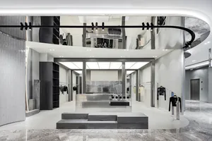 Interior of a modern retail store featuring concrete floors, minimalist design, and a clean, contemporary aesthetic.