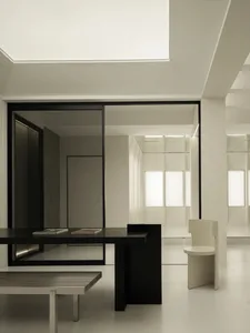 Modern minimalist office space featuring black and white furniture and decor.