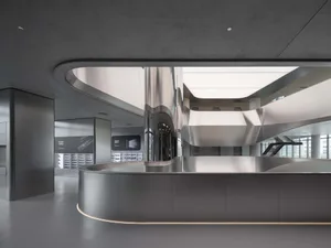 Contemporary office lobby with modern design elements, featuring glass and concrete materials.