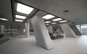 Modern office interior with concrete columns and white flooring.
