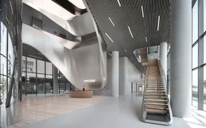 Modern office reception area with metallic concrete elements, featuring a curved wall and a spiral staircase.