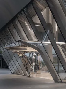 A futuristic architectural structure with metallic and glass elements.