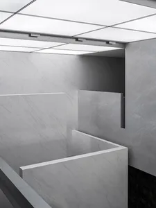 A modern office space featuring marble and concrete materials.