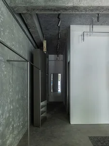 Industrial-style interior with concrete walls, minimalist design, and modern decor.