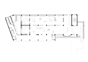 Floor plan of an industrial-style office space, featuring open workstations and meeting areas.