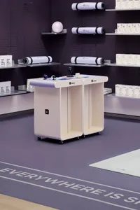 Industrial-style products display with metal shelves and rolling tables.