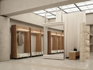 A minimalist clothing fit station featuring marble countertops and wooden fixtures.