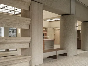 Modern interior space with concrete columns and marble benches.