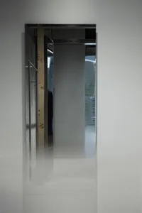 A modern interior space featuring a glass wall