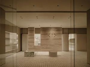 A minimalist retail store with a terrazzo floor.