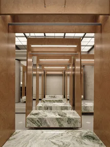 A retail dress fitting room with marble and wooden fixtures