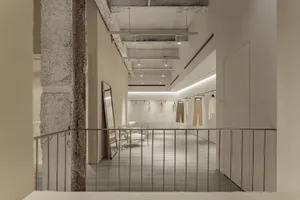 Minimalist retail space with concrete walls and ceiling.