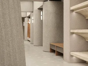 A modern interior space featuring concrete columns and a well-lit corridor with wooden benches.