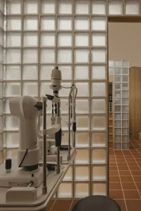 A modern medical clinic with a glass block wall and specialized equipment.