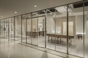 Modern retail storefront with glass window frame, concrete ceiling, and minimalist design