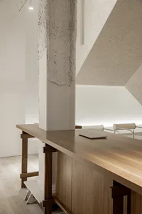 Minimalist workspace with wooden furniture and sleek, modern design.