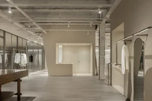 A minimalist clothing boutique featuring concrete and glass materials.