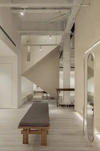 A modern retail space featuring elements of concrete, wood, and metal.